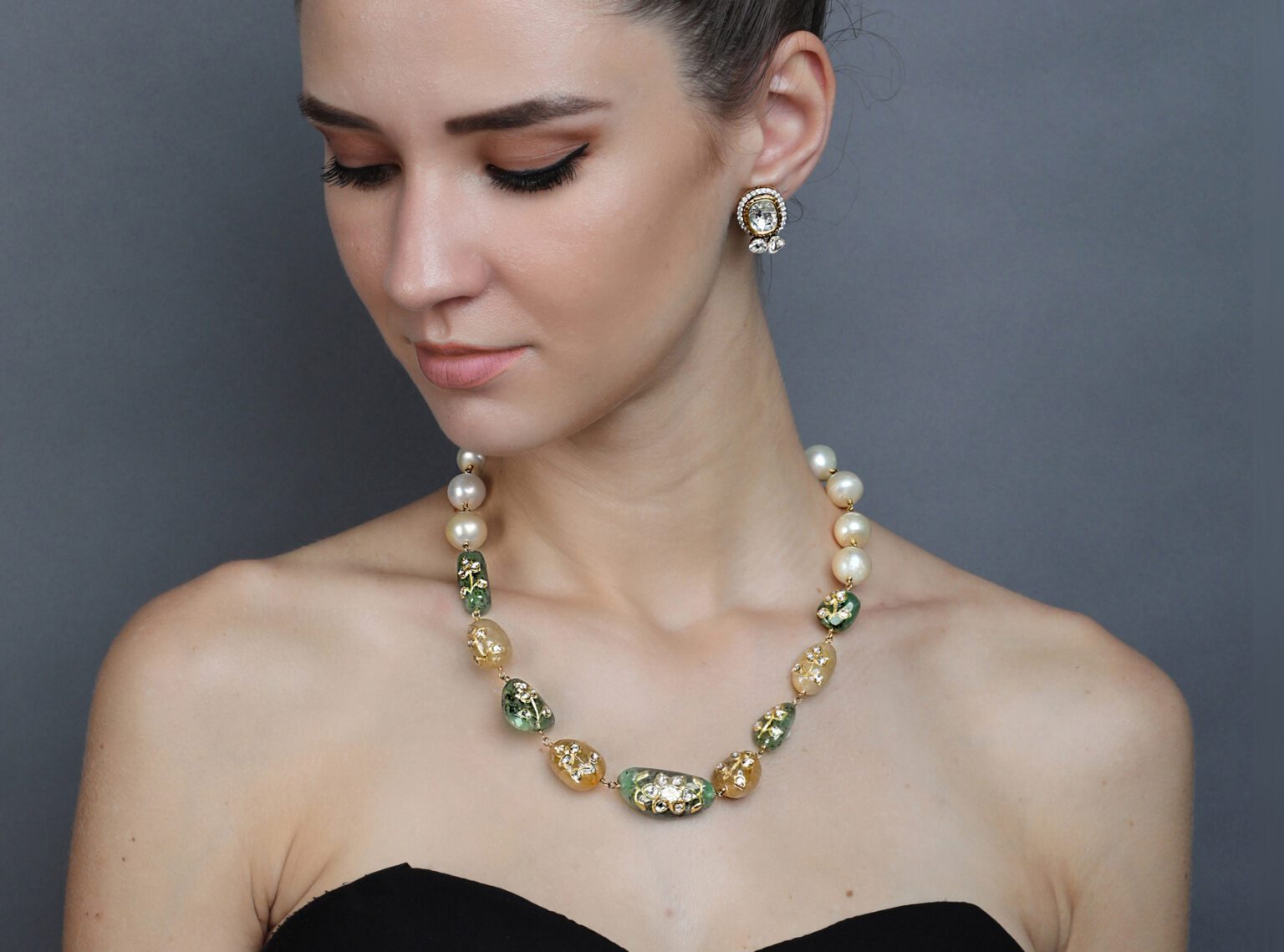 Model wearing luxury stone earrings and necklace captured in jewellery campaign photography by Productpixels Singapore