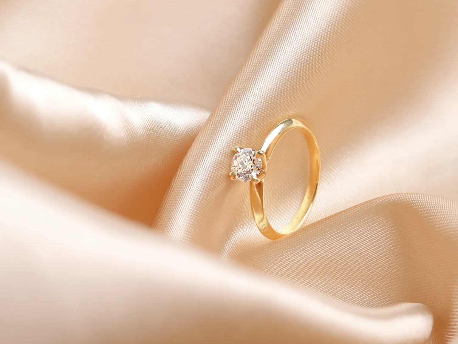 Solitaire diamond ring photographed on silk by Productpixels, a professional jewellery photography studio in Singapore.
