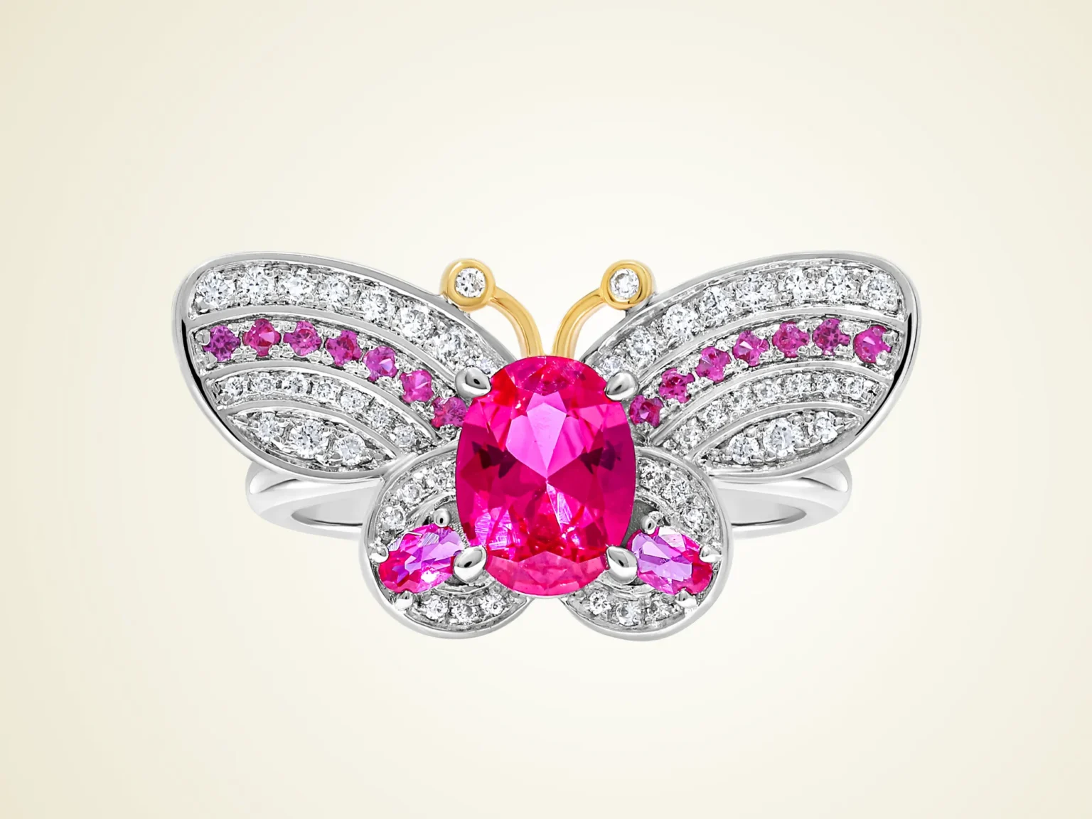 Helene Quan Papillon Rose butterfly ring in white gold with pink sapphires and diamonds on a light cream background.