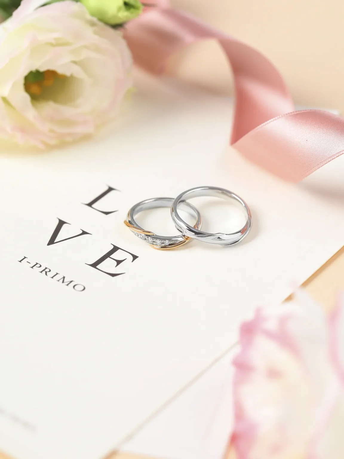 Wedding rings on invitation card with flowers captured in lifestyle jewellery photography by Productpixels Singapore
