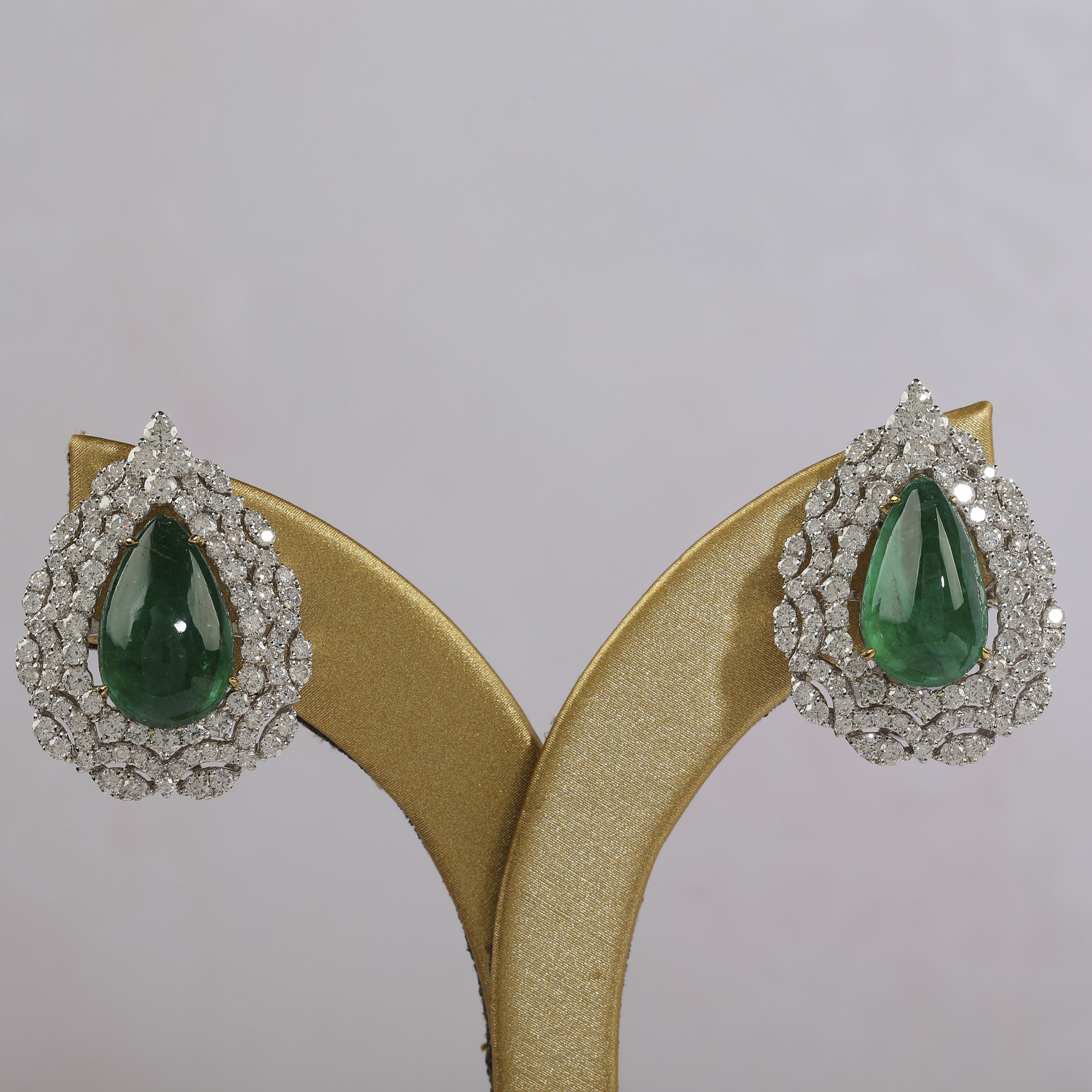 Raw jewellery product image of green gemstone earrings with visible fingerprints, support setup and uneven presentation before retouching Productpixels Singapore
