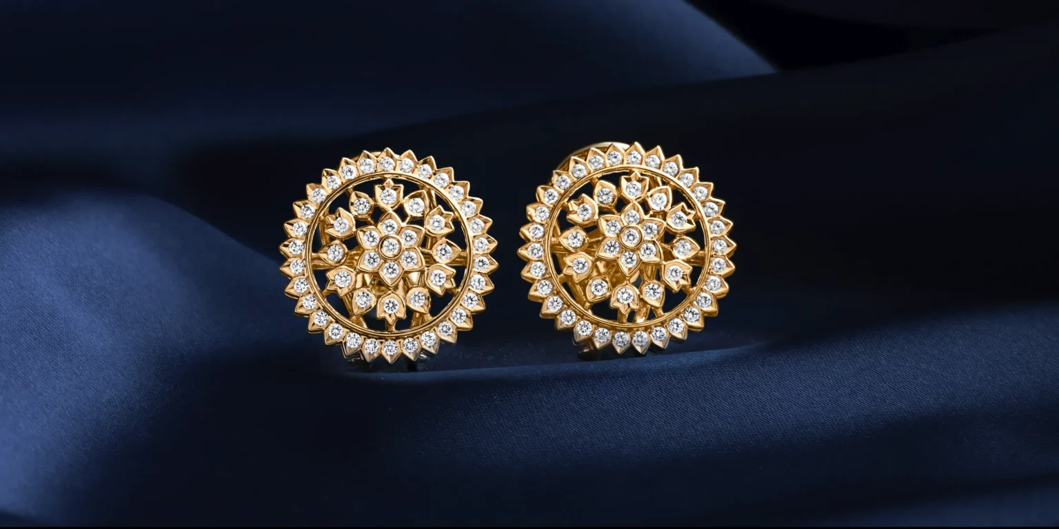 Luxury gold diamond stud earrings jewellery photography on dark blue fabric background by Productpixels Singapore