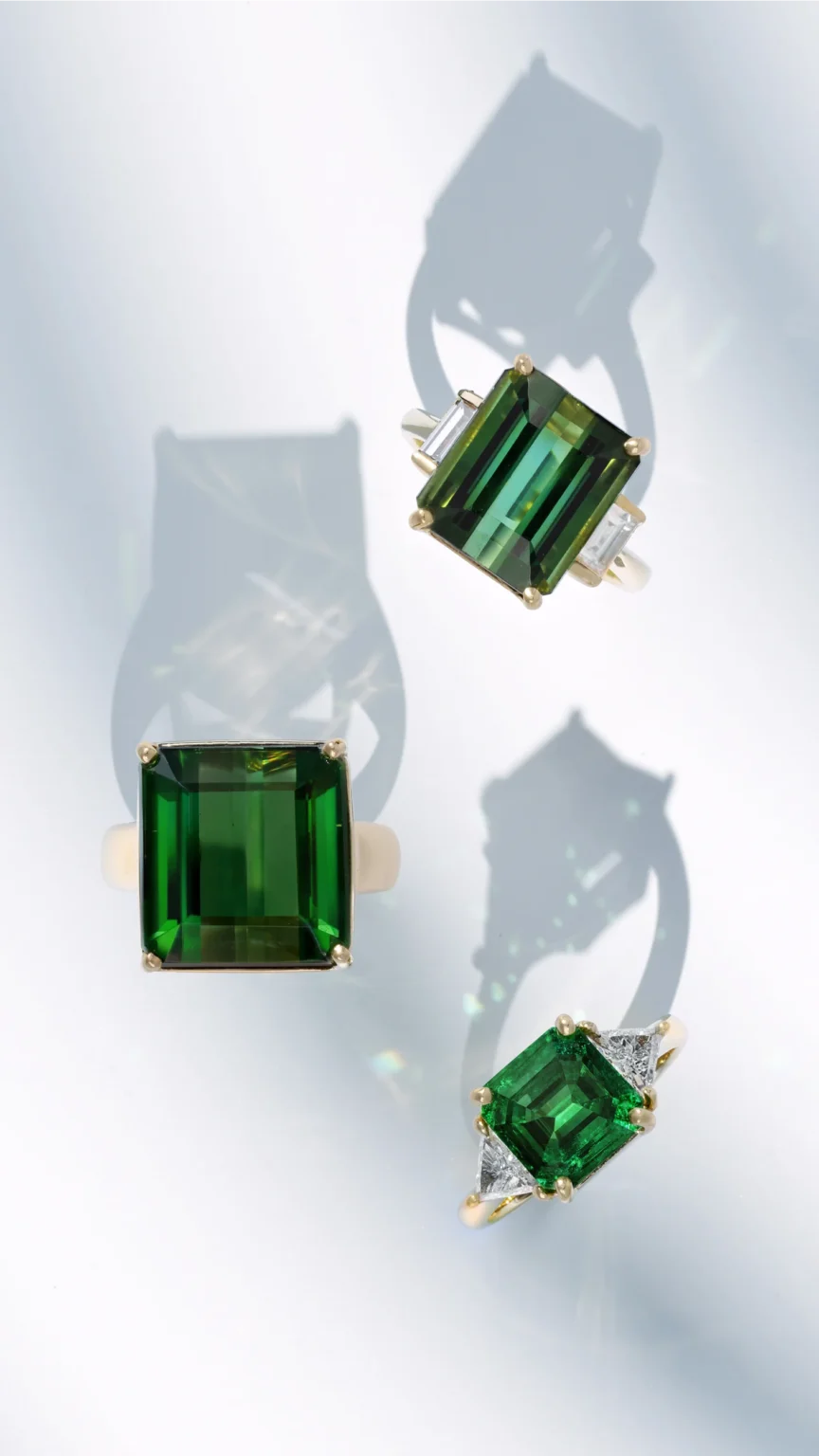 High-end jewellery photography of emerald rings highlighting colour depth, clarity and modern styling with shadows