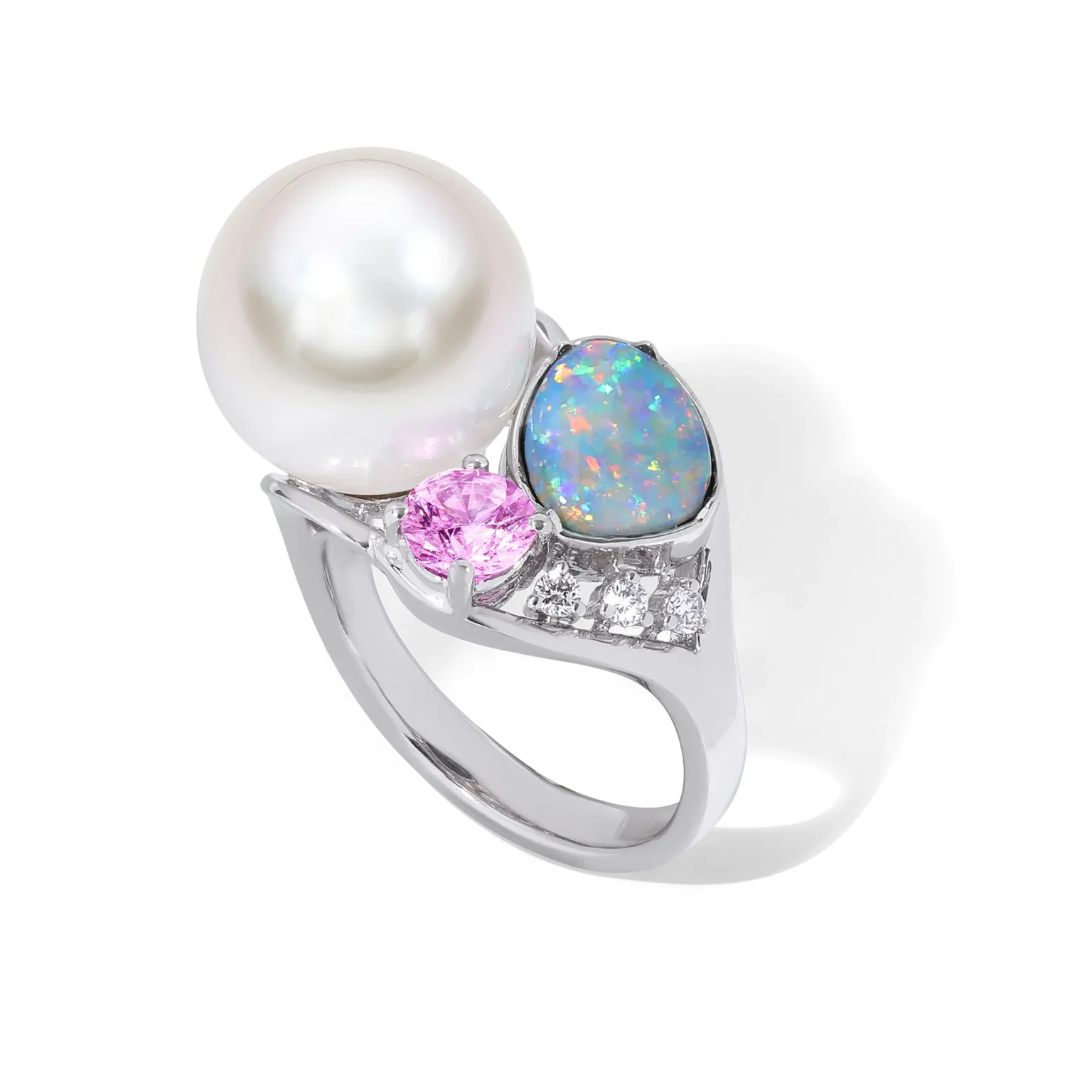 High-end jewellery photography showcasing a unique pearl and opal ring with pink gemstone and diamond accents, captured with precision lighting to enhance iridescence, colour play and fine craftsmanship.