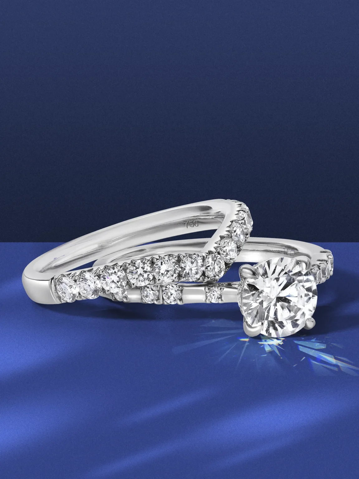 Professional jewellery photography of diamond engagement ring with pav&eacute; diamonds in white gold, shot on blue background by ProductPixels Singapore