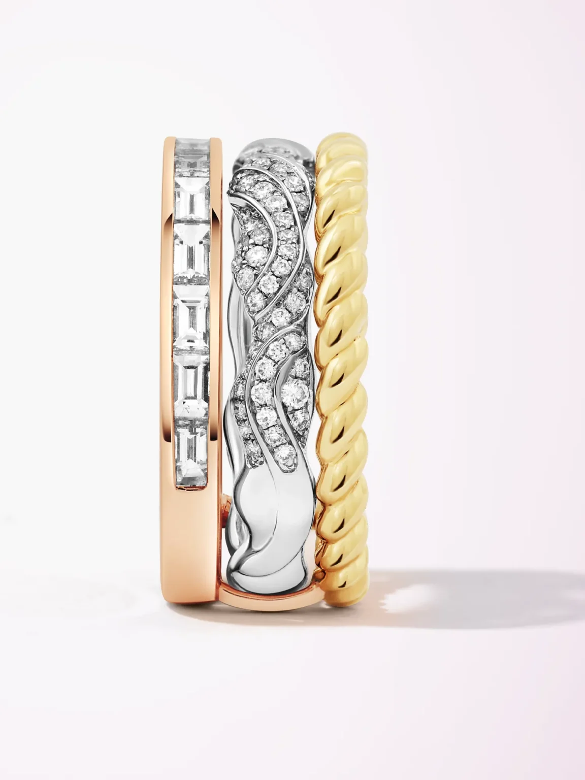 Luxury gold and diamond ring stack photography featuring mixed metal bands with baguette and pav&eacute; diamonds, by ProductPixels Singapore