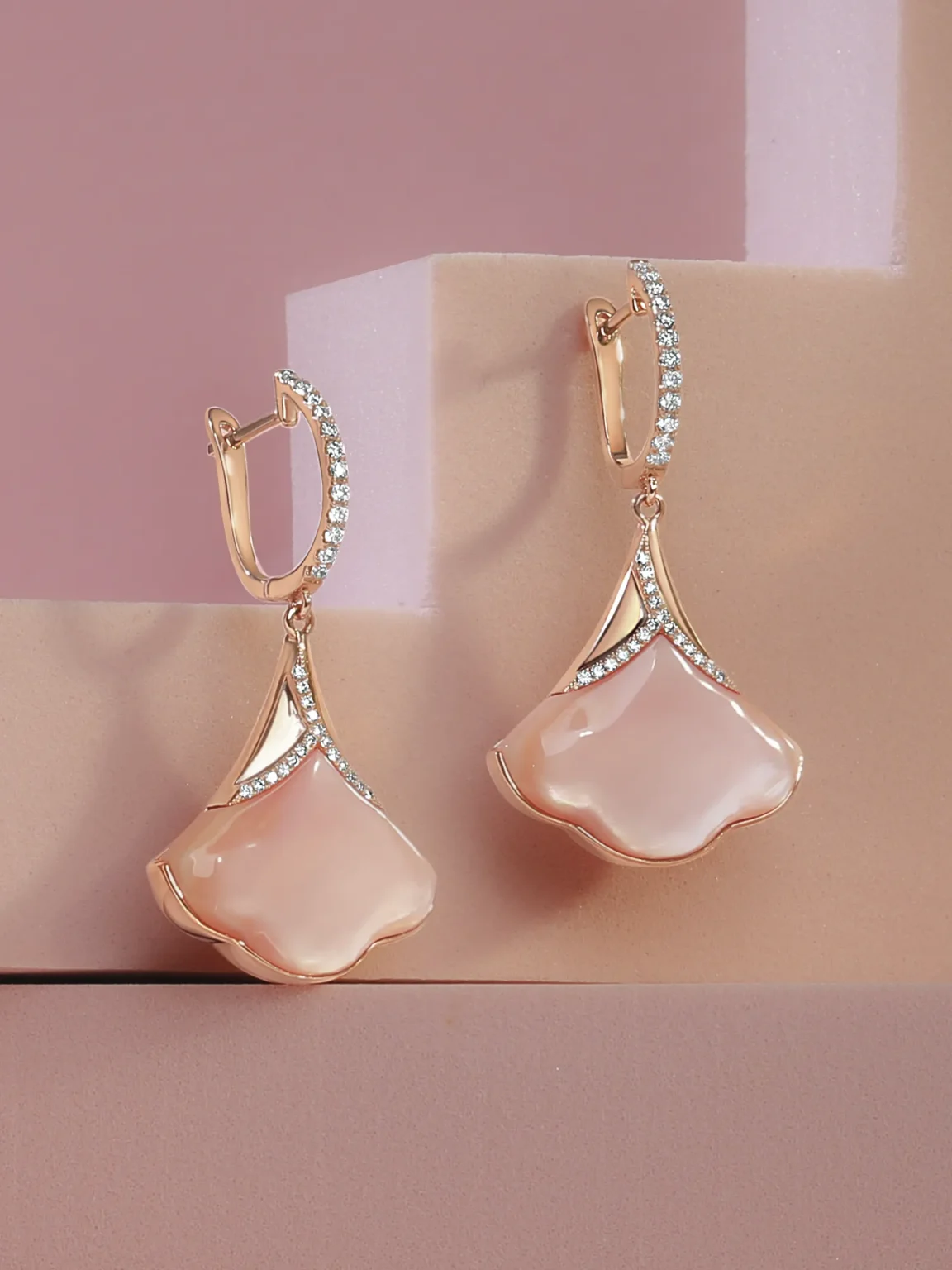 Professional jewellery photography of rose gold pastel gemstone drop earrings with diamond details, shot on styled background by ProductPixels Singapore