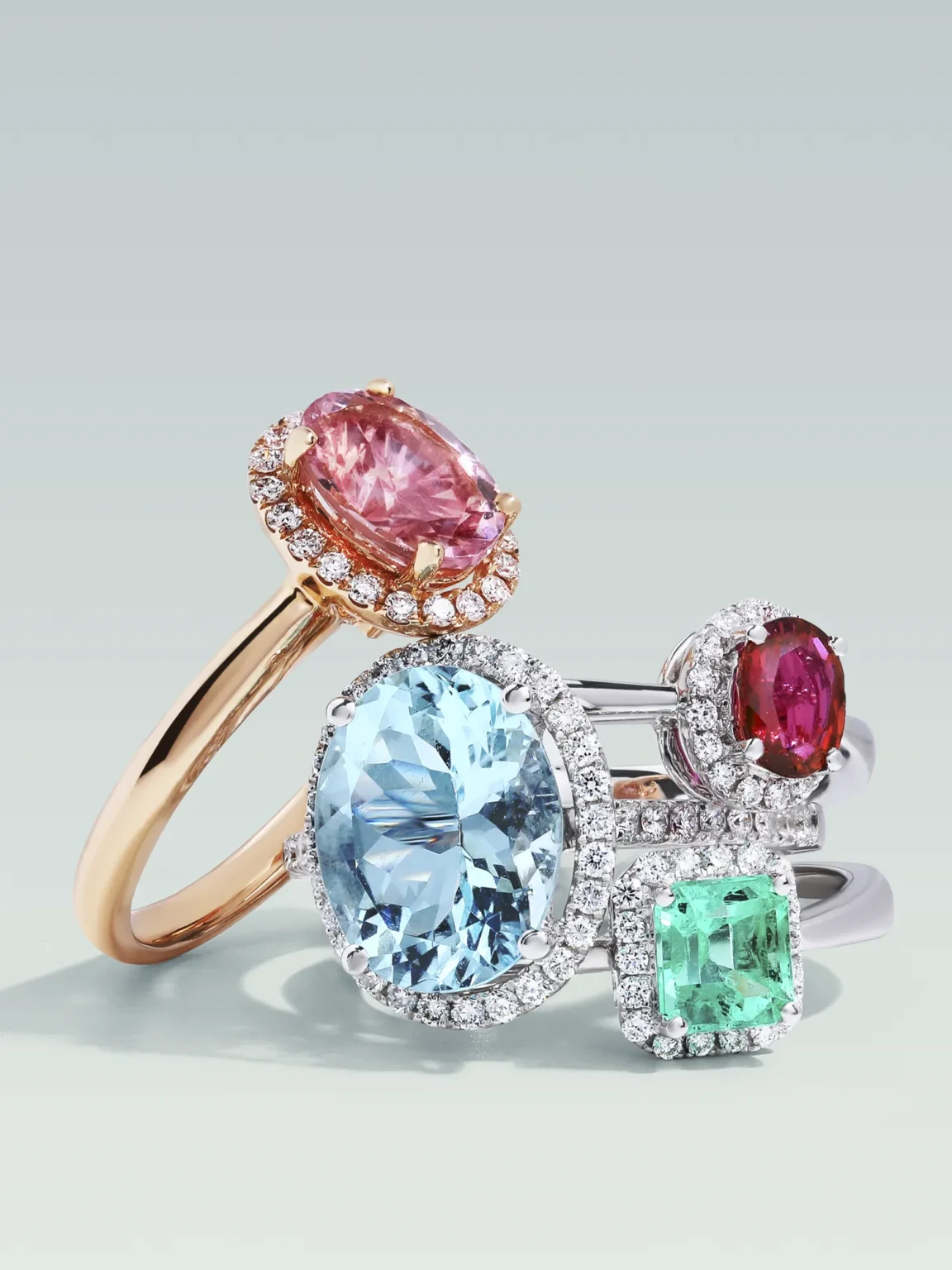 Professional jewellery photography of luxury gemstone rings with aquamarine, sapphire, ruby and emerald, shot on clean background by ProductPixels Singapore