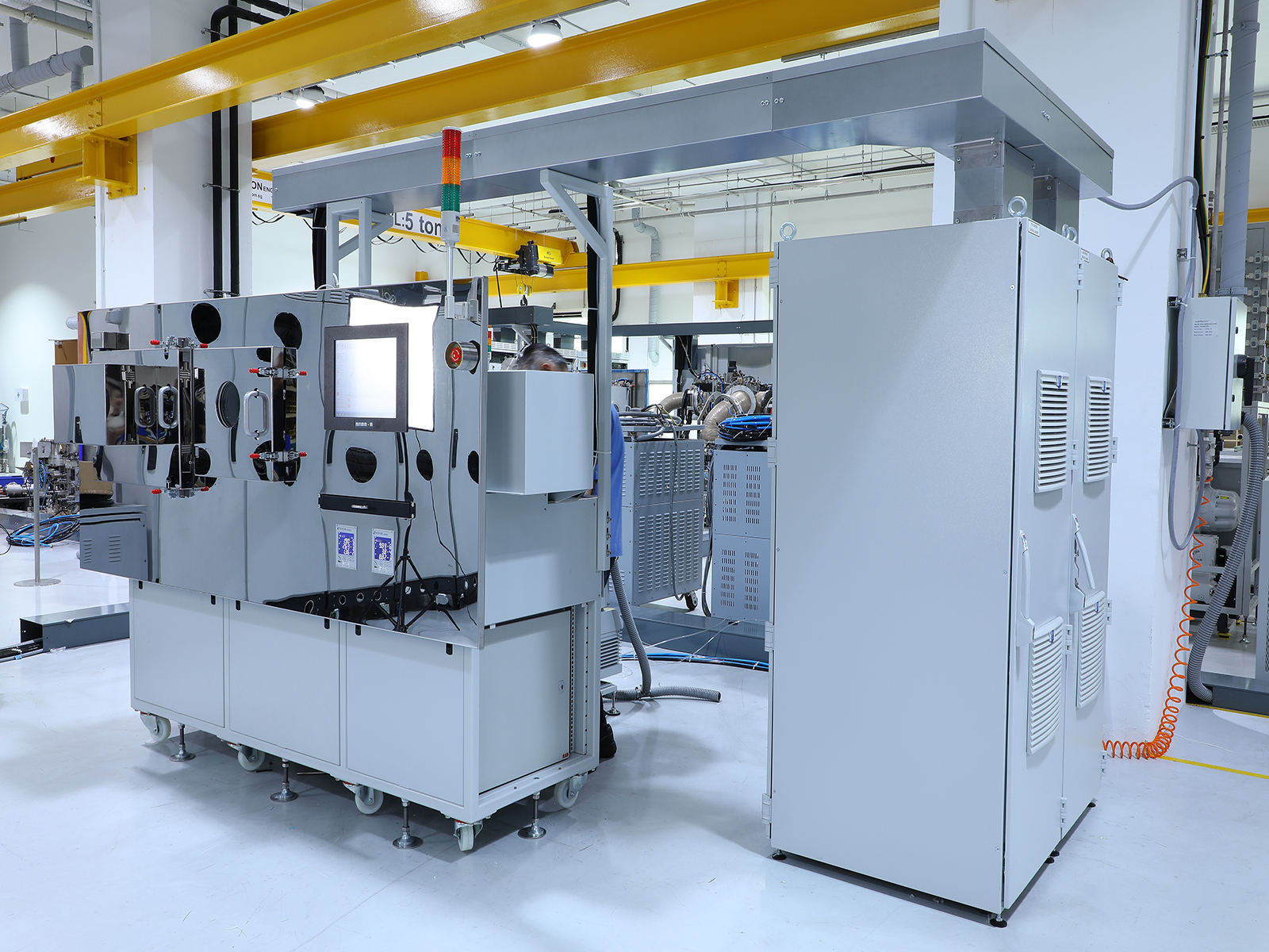 Industrial machinery photographed inside a factory environment before professional retouching, showing production surroundings, uneven lighting, and background distractions.